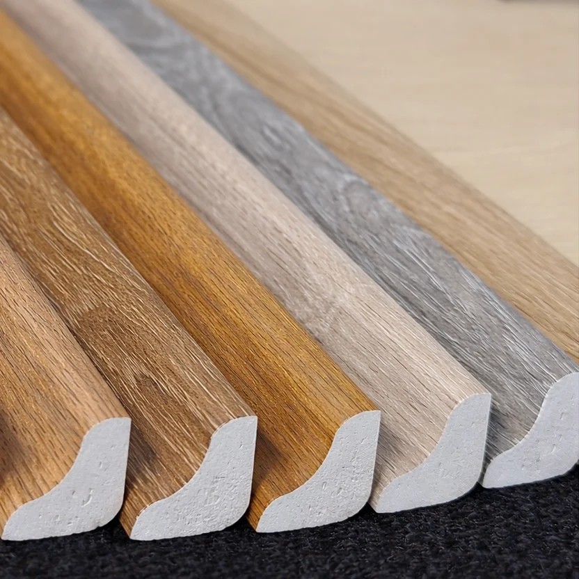Colour-matched scotia profiles fanned out in five timber-look finishes